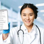 Médica segura um celular mostrando o app da Receita Federal com a funcionalidade do Receita Saúde.